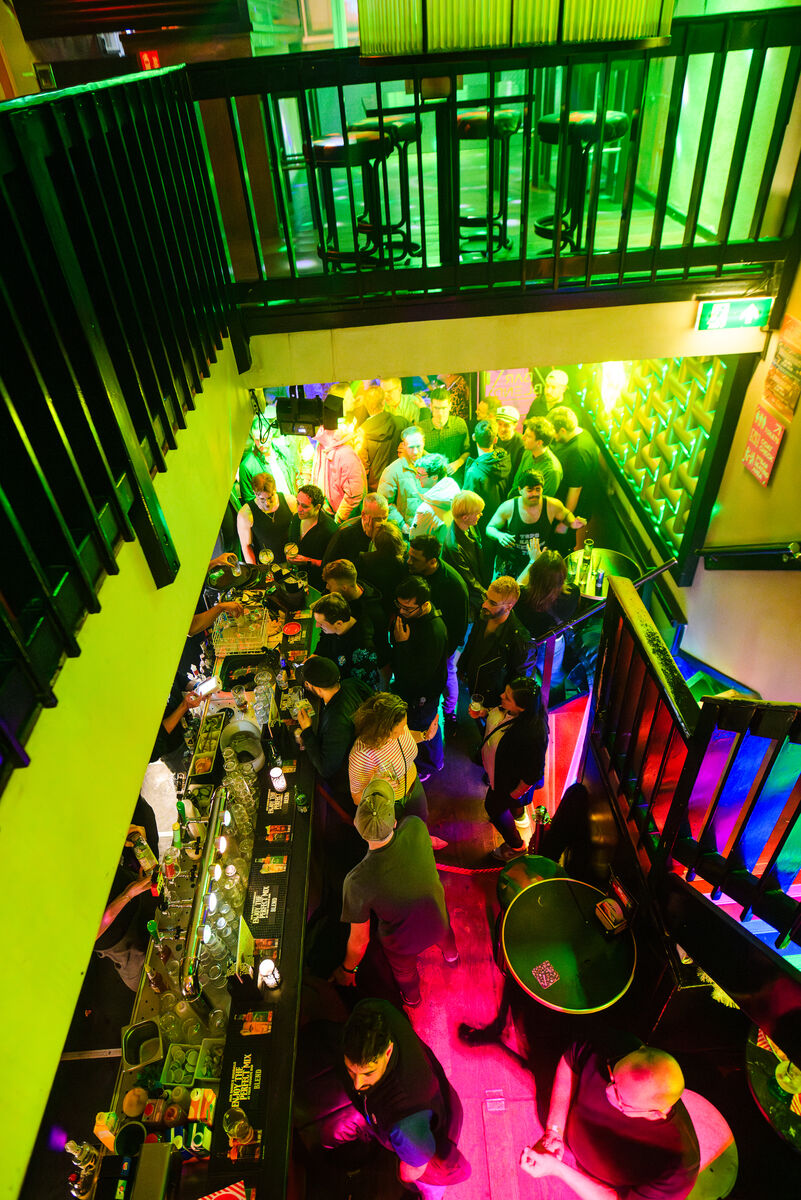 View from the stairs over the bar and crowd at Bar Blend Amsterdam