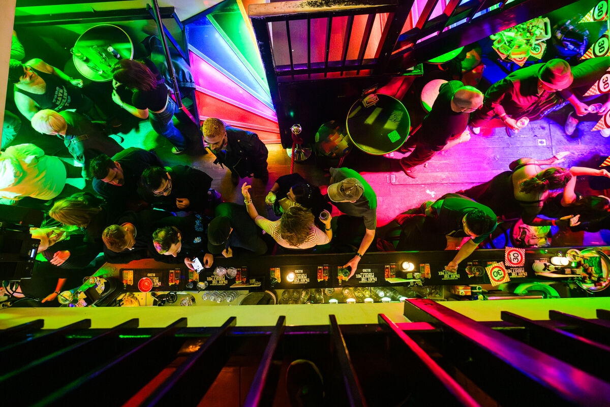 Top-down view of the bar and guests under rainbow lights at Bar Blend Amsterdam