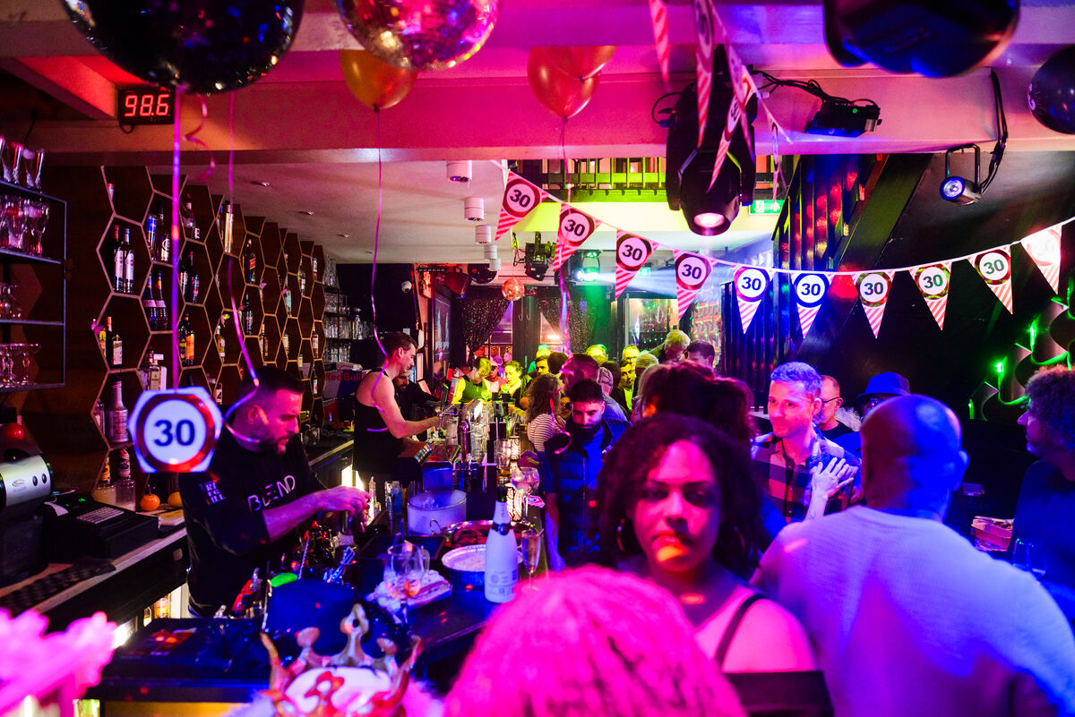 Full bar room with disco balls and party bunting at Bar Blend Amsterdam