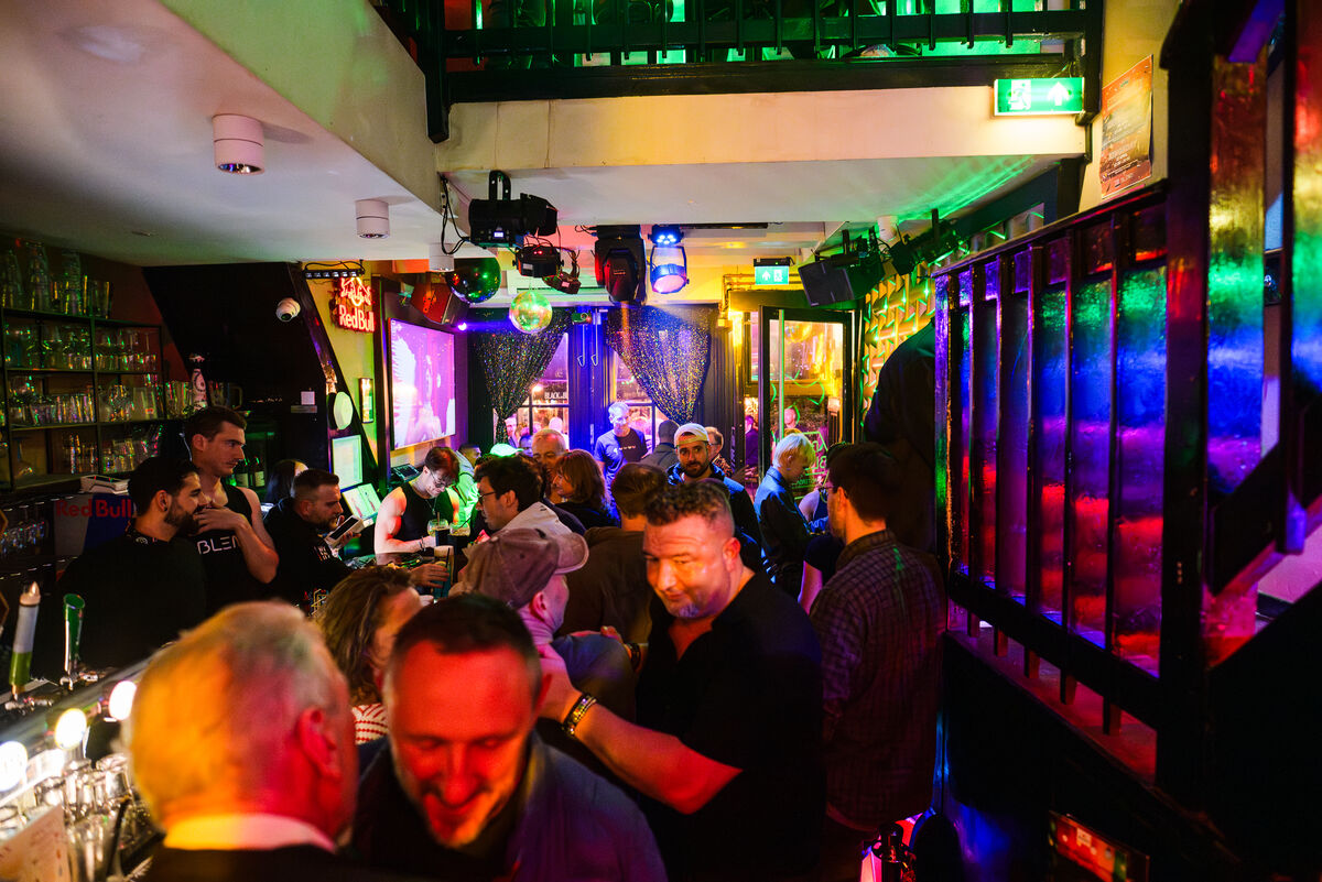 Crowded bar room with neon lights and disco ball at Bar Blend Amsterdam
