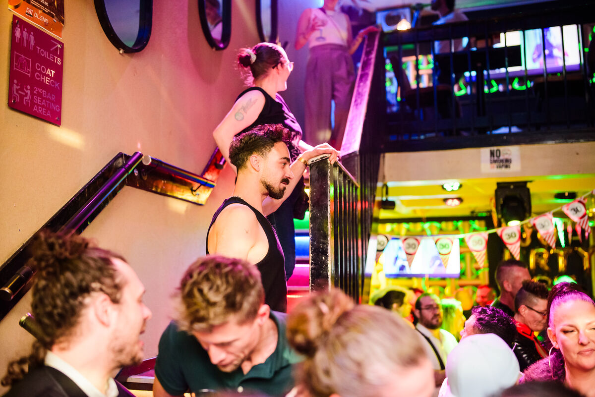 Guests on the staircase by the coat check at Bar Blend Amsterdam