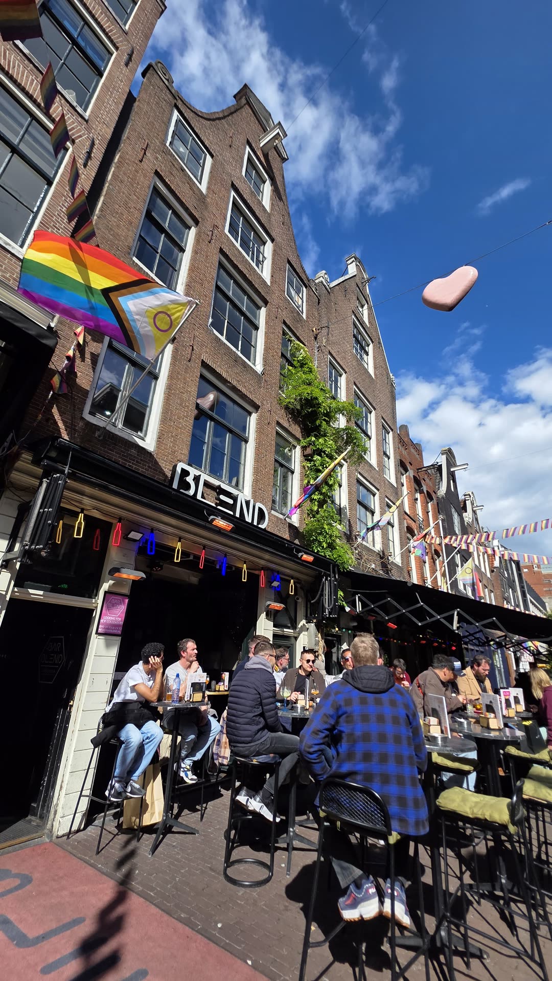 Bar Blend facade and terrace on a sunny day with Pride flags on Reguliersdwarsstraat Amsterdam