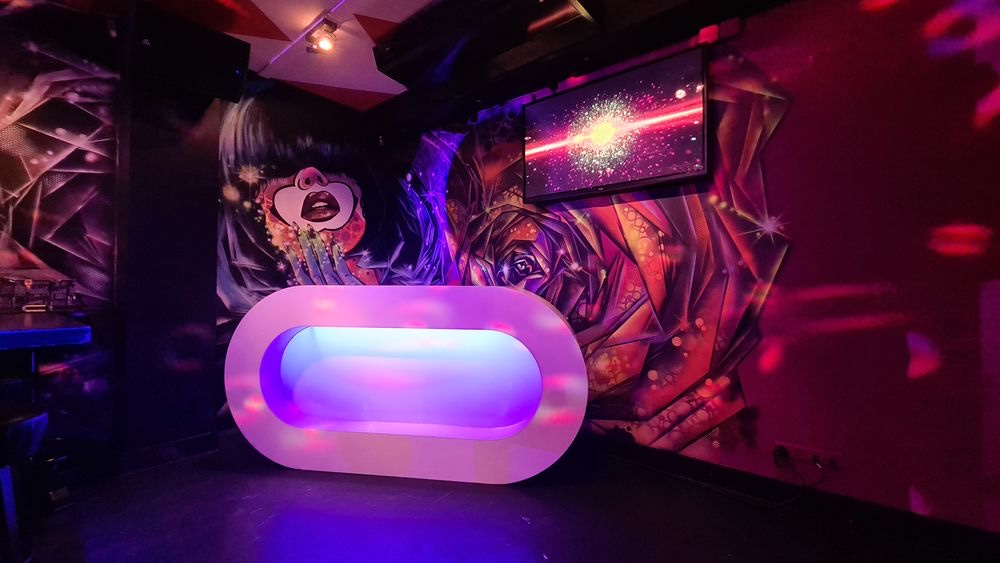 Blend XL DJ booth and mural wall The illuminated DJ booth and hand-painted mural wall in the second room at Blend XL Amsterdam