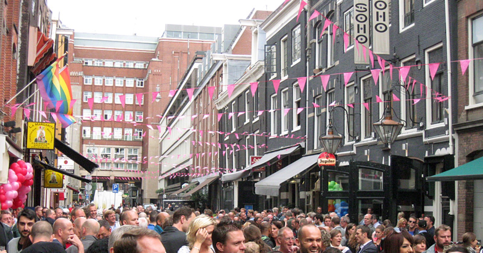 Pride crowd and rainbow flags on Reguliersdwarsstraat in front of Montmartre XL Amsterdam